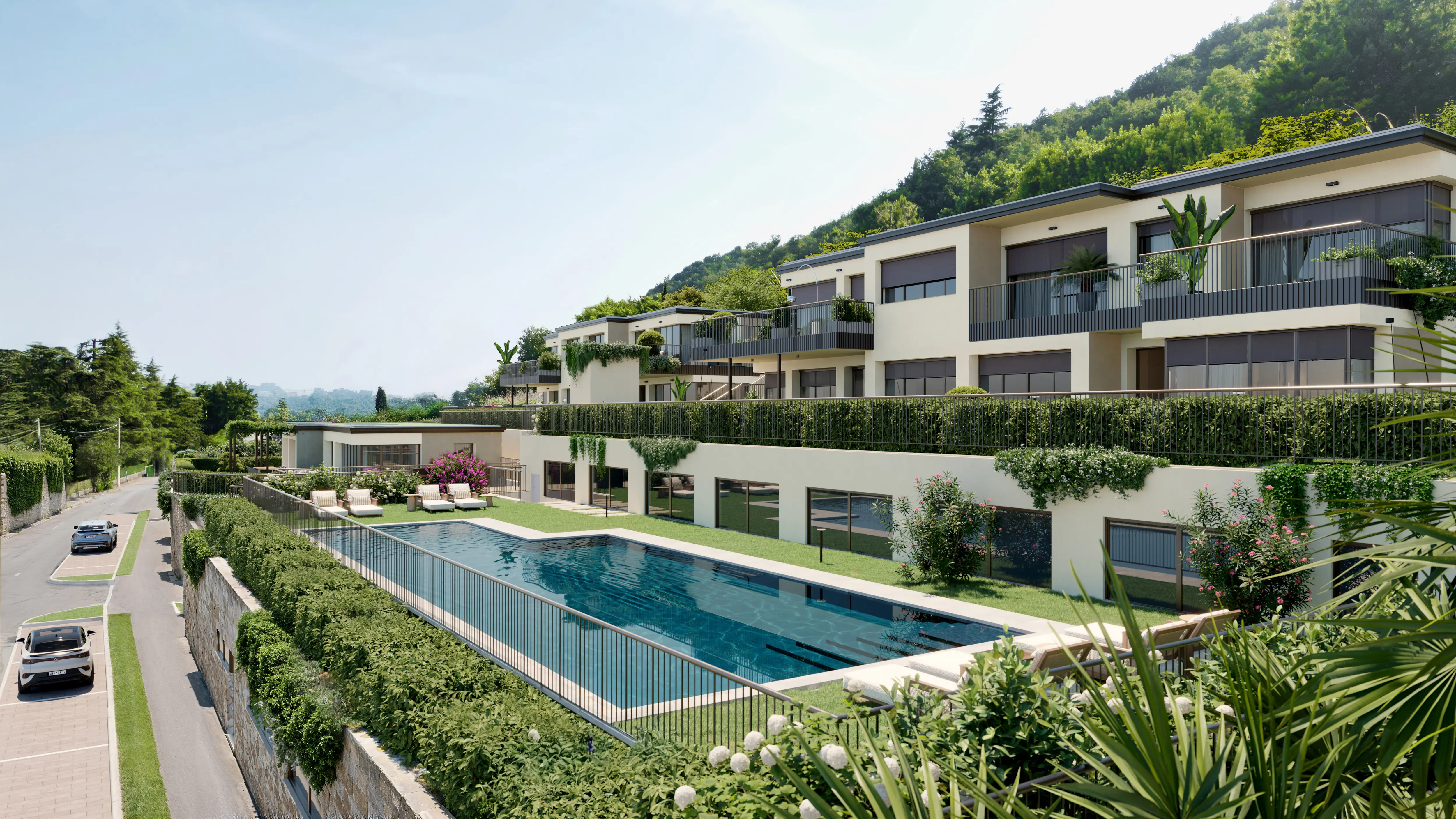 Modern multi-level residential building with balconies, surrounded by greenery and a rectangular outdoor swimming pool.