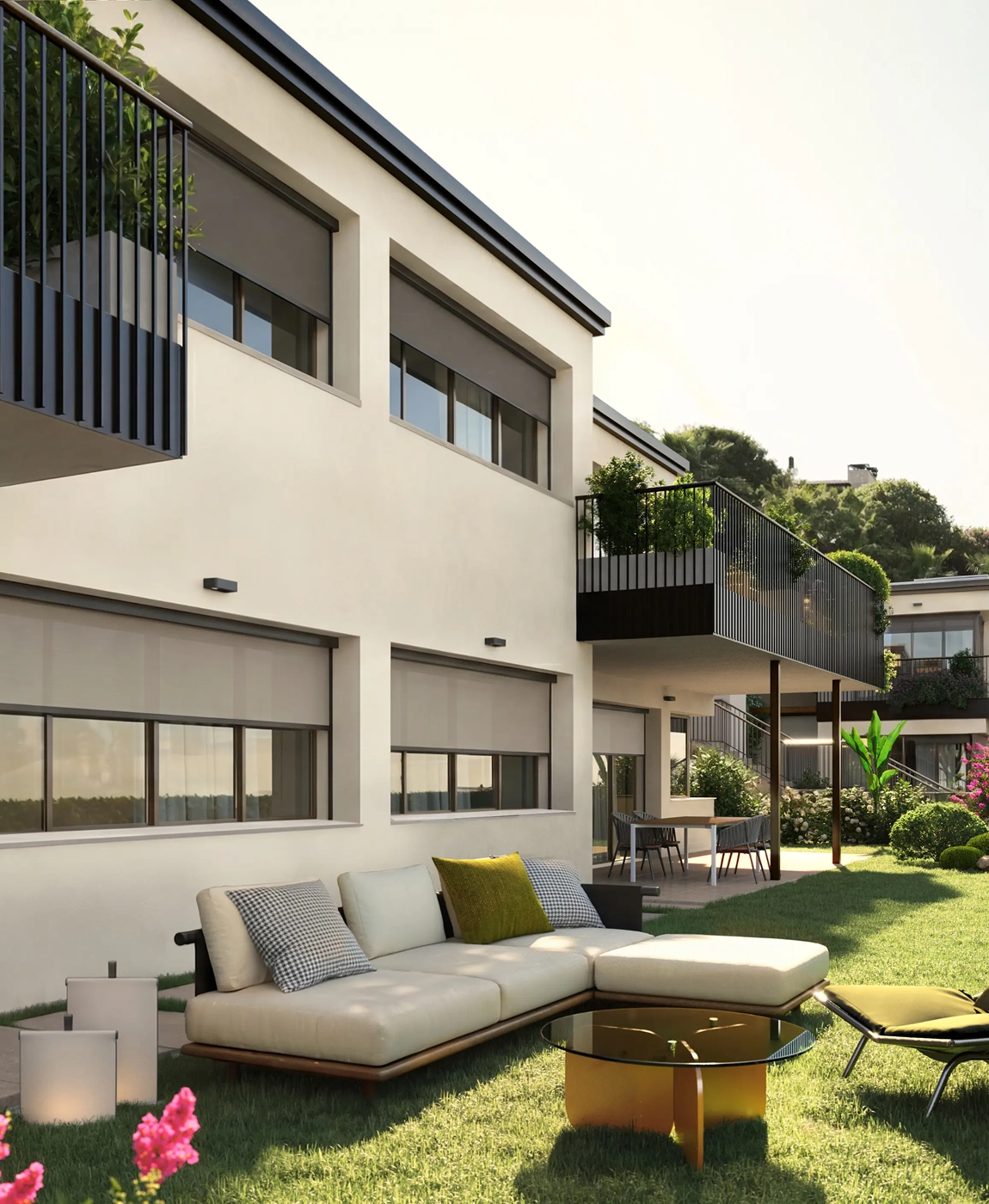 Modern two-story house with beige exterior, large windows, balconies with plants, and an outdoor seating area with a cream sectional sofa, glass coffee table, and green grass lawn.