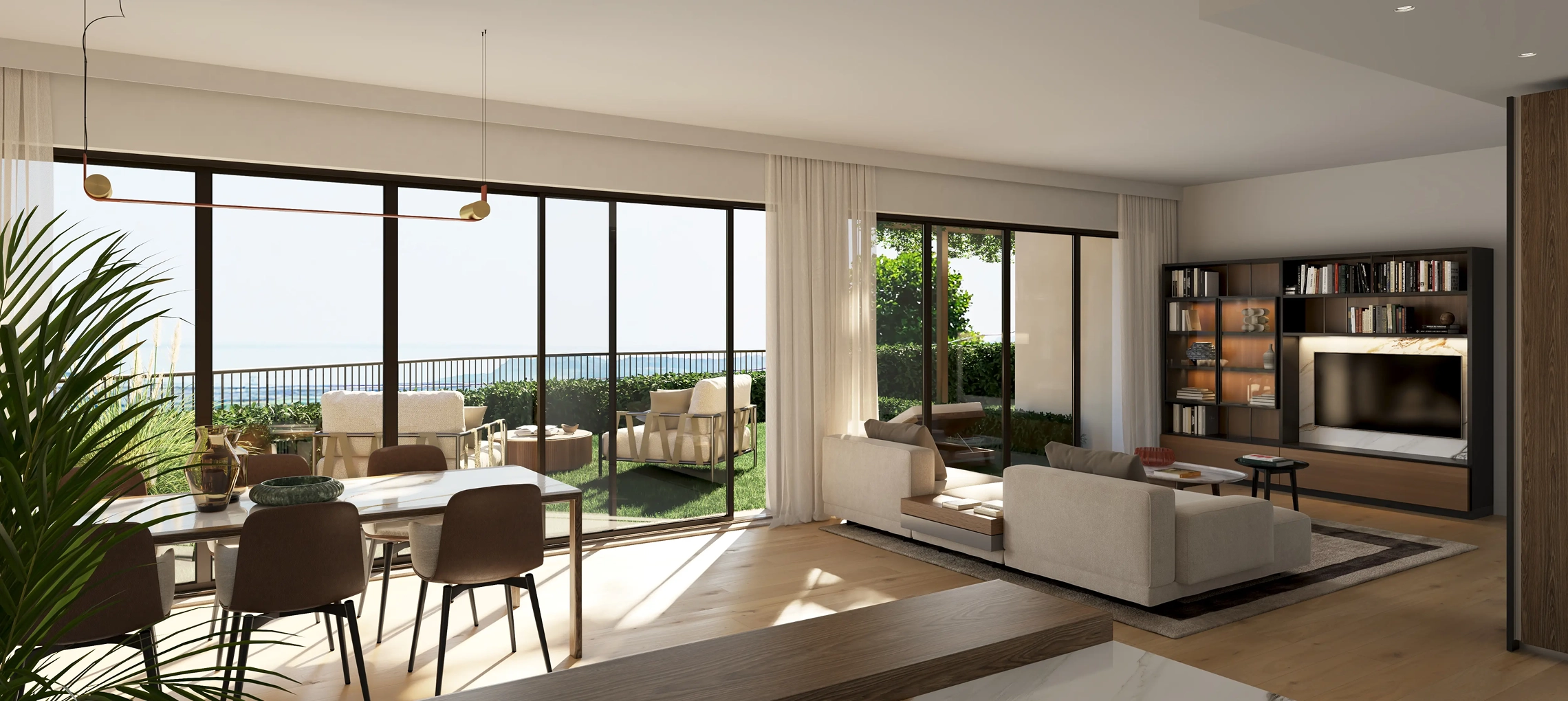 Modern open living and dining area with large glass doors opening to outdoor seating and greenery.